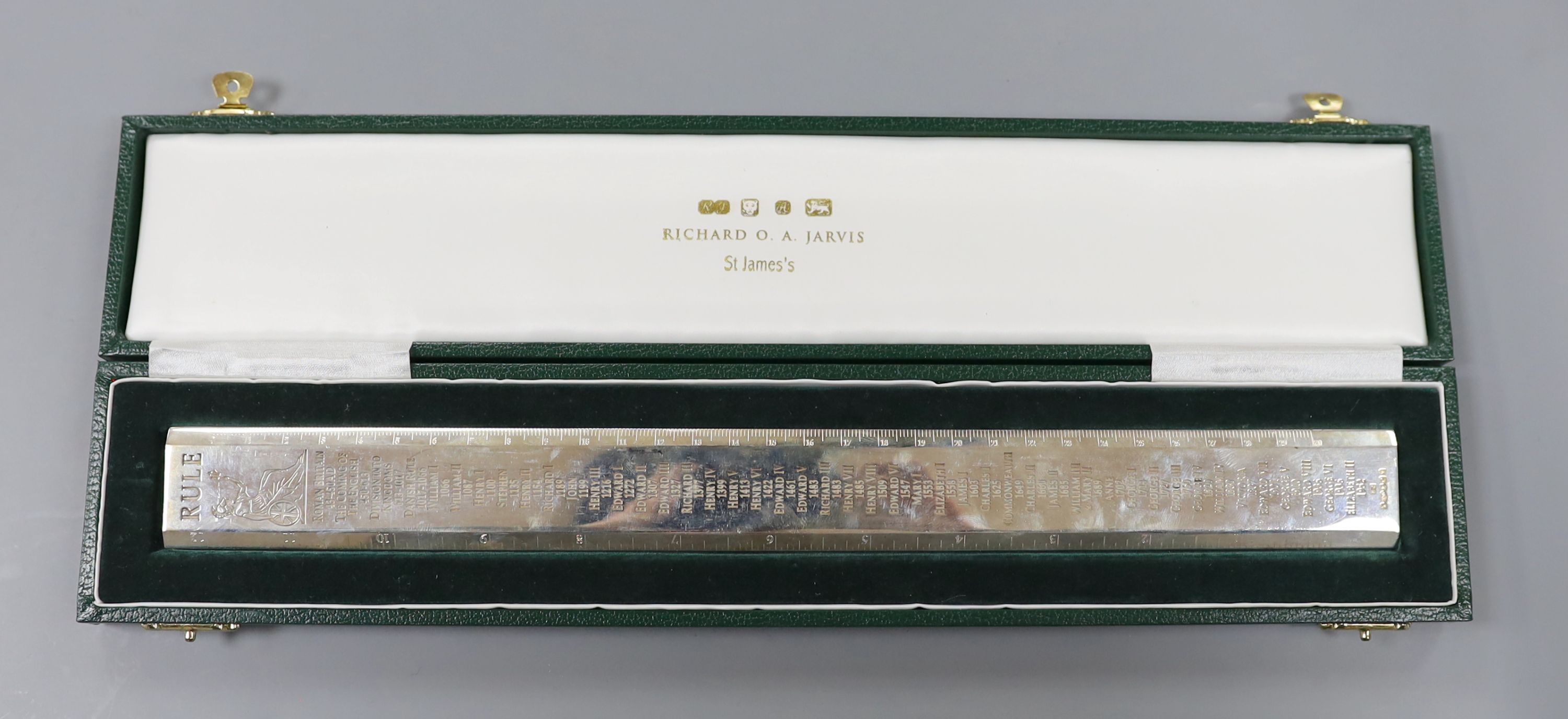 A cased modern Britannia standard silver 'Rule' ruler, engraved with the names and dates of the English Monarchy, by Richard O. A. Jarvis, London, 1977, 9.5oz.